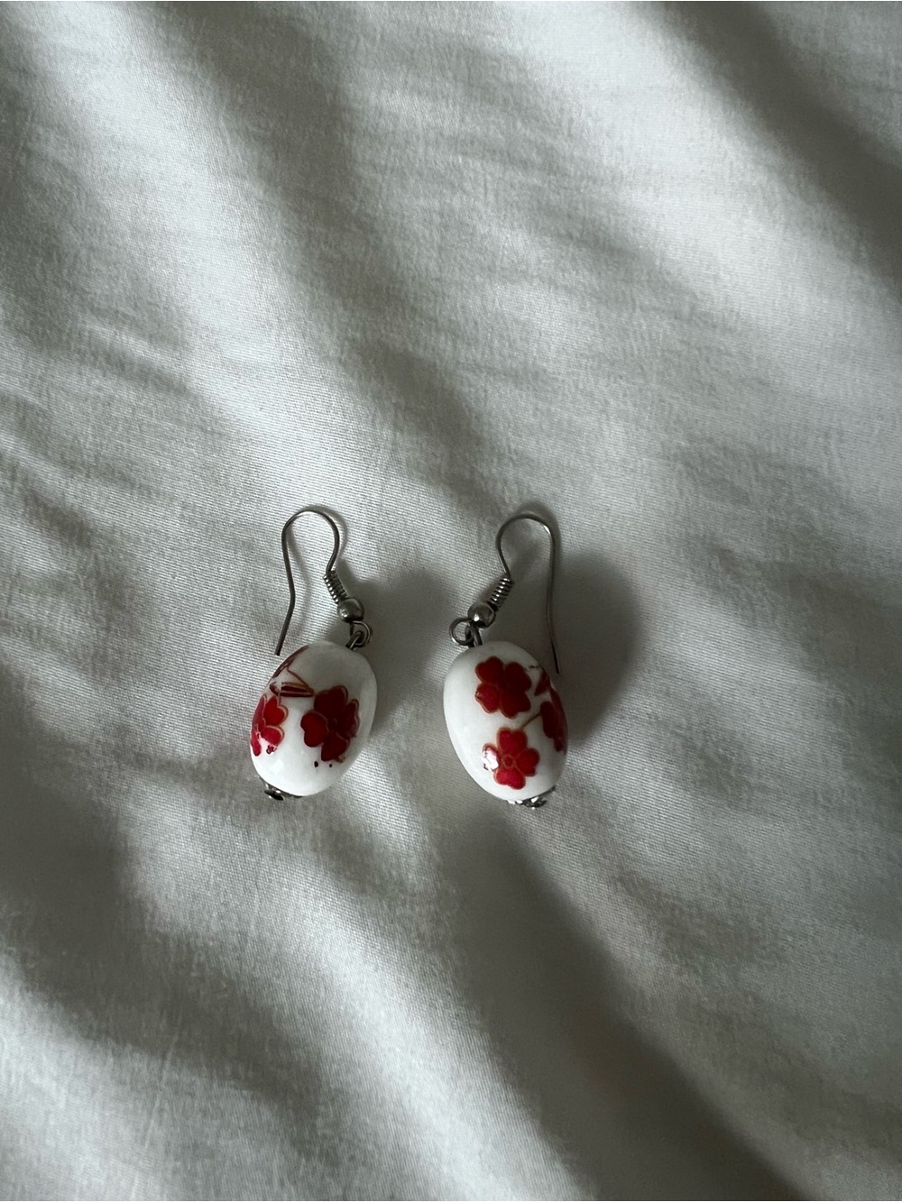 White Bead Drop Earrings with Red Floral Design